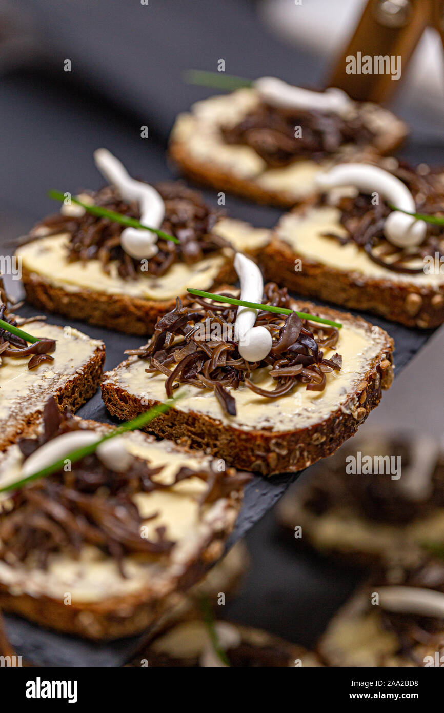 Nocette di truffel con burro speziato decorate con i funghi commestibili Foto Stock