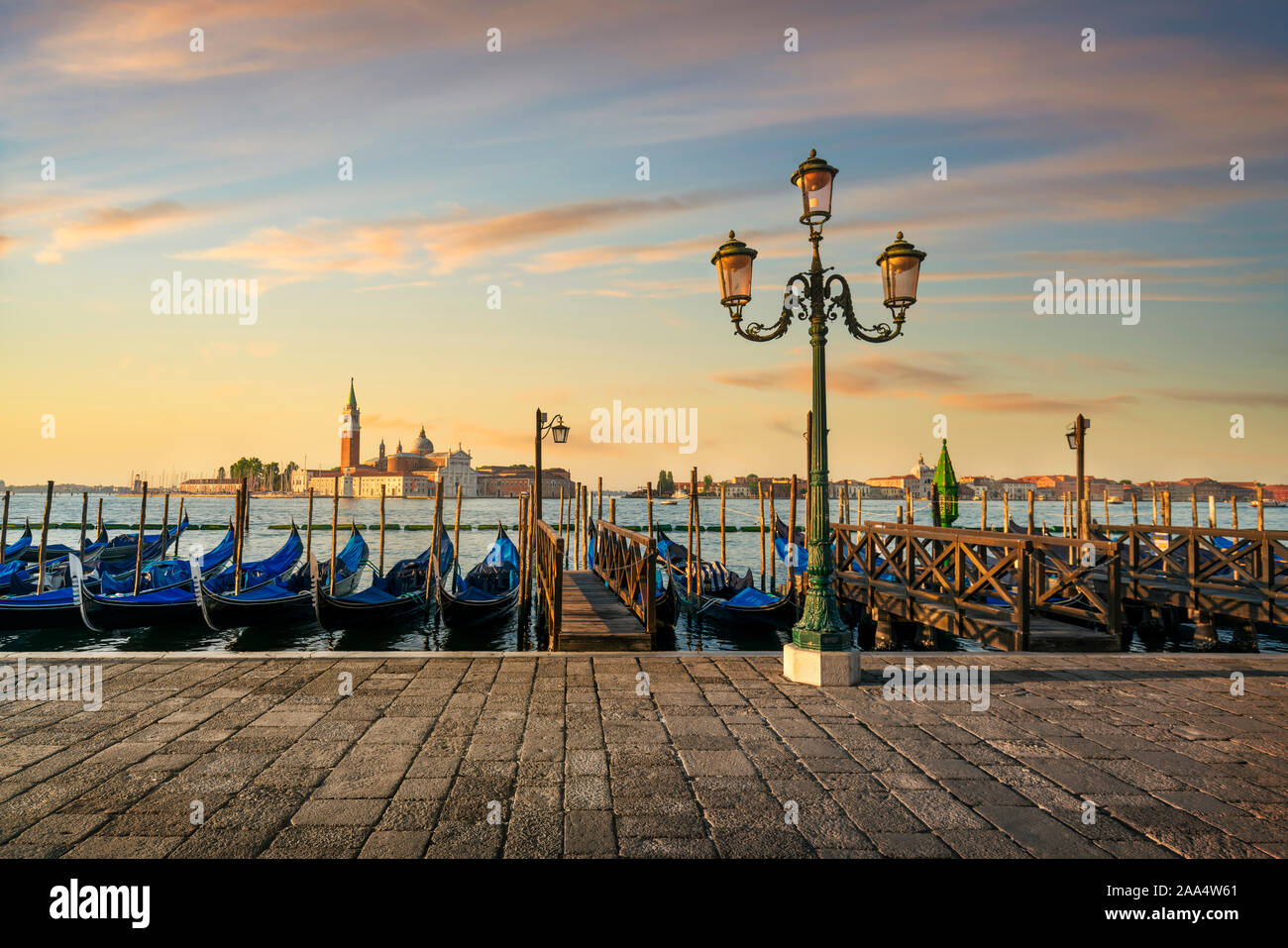 La laguna di Venezia al sunrise, chiesa di San Giorgio Maggiore, le gondole e lampione. L'Italia, l'Europa. Foto Stock