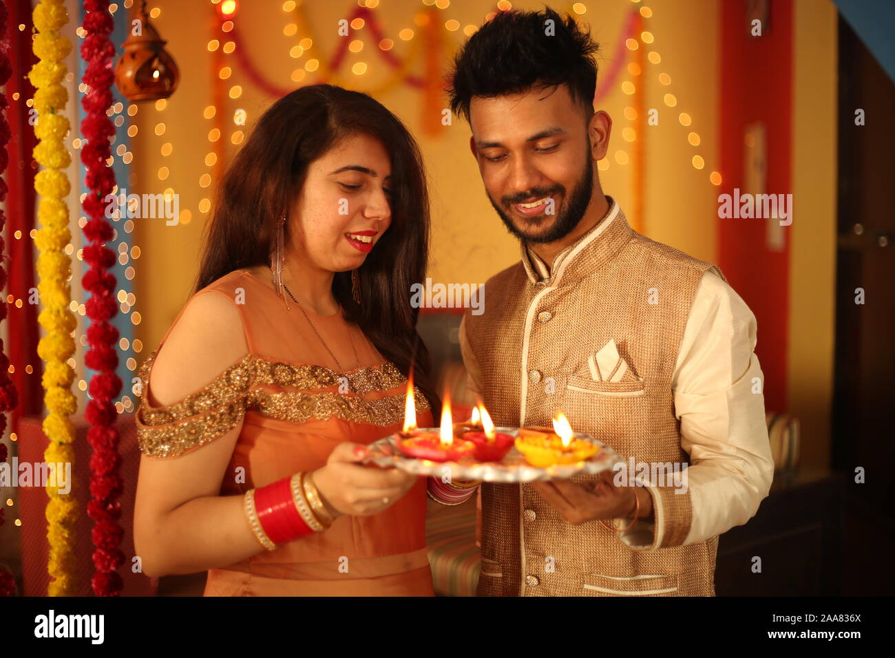Indian giovane celebra Diwali. Isolato su sfondo decorativo. Foto Stock