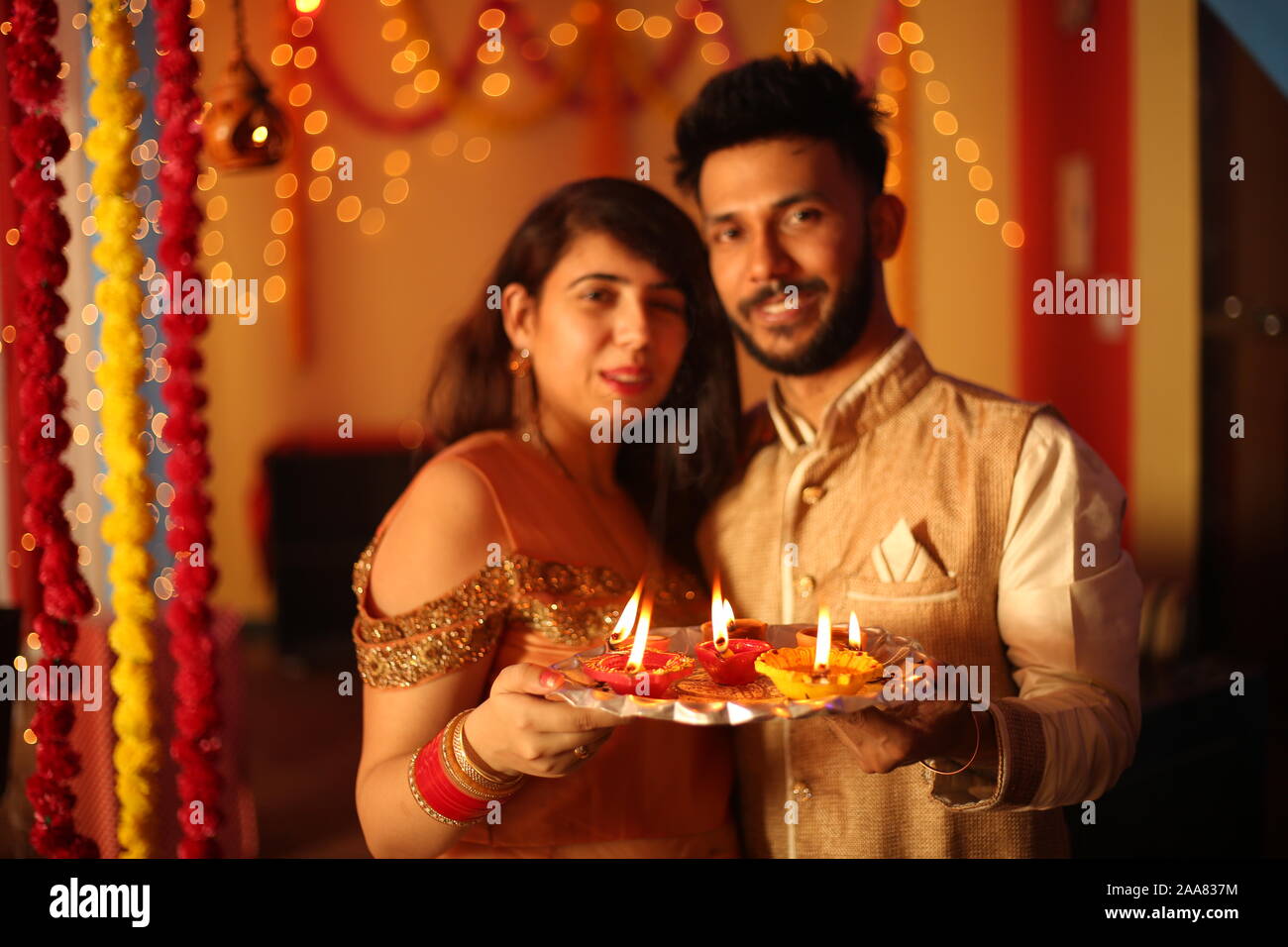Indian giovane celebra Diwali. Isolato su sfondo decorativo. Foto Stock