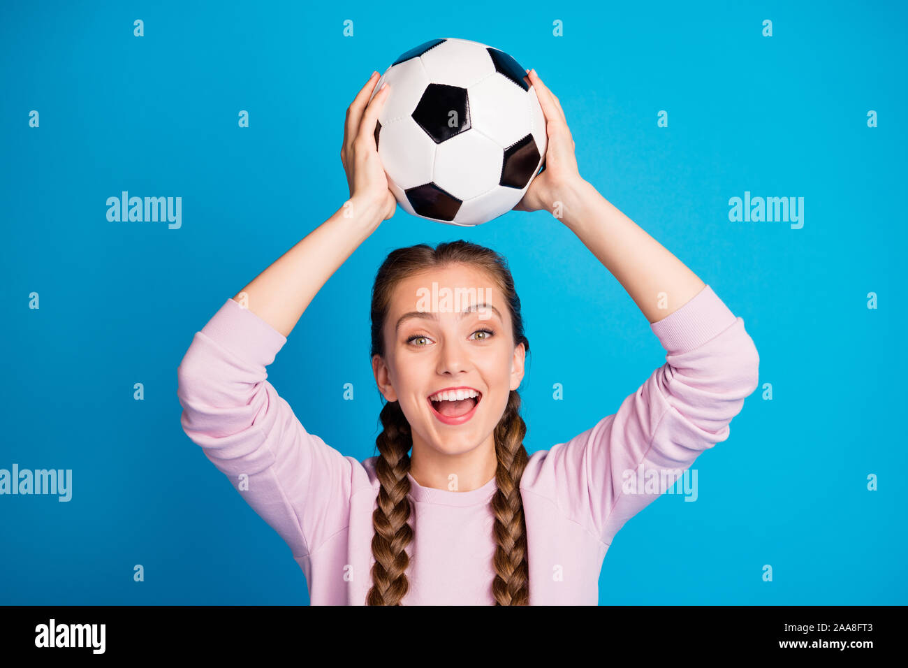 Close up foto di allegra gioventù divertente tenere piede palla guarda league world cup match sento crazy eccitato indossare uno stile informale abbigliamento isolate su blu Foto Stock