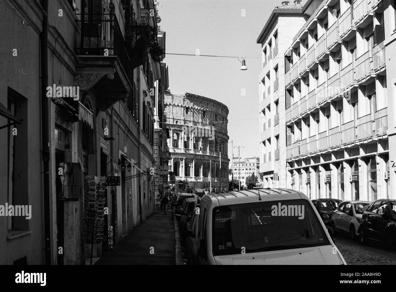 Una pellicola di 35mm foto in bianco e nero del Colosseo come si vede da una delle strade locali di Roma, Italia Foto Stock