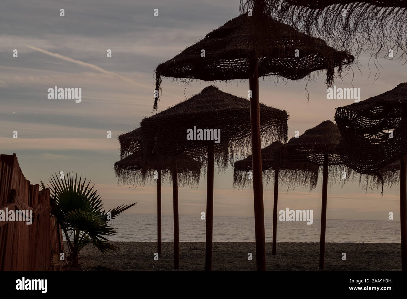 Più ombrelloni sulla spiaggia deserta di Nerja, Spagna Foto Stock