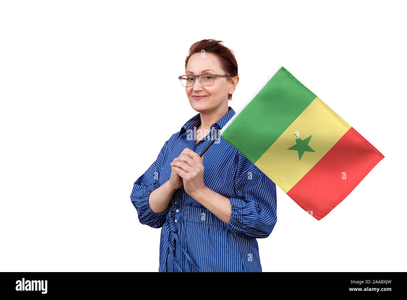 Senegal bandiera. Donna che mantiene il Senegal bandiera. Bel ritratto di mezza età lady 40 50 anni tenendo un grande bandiera isolati su sfondo bianco. Foto Stock