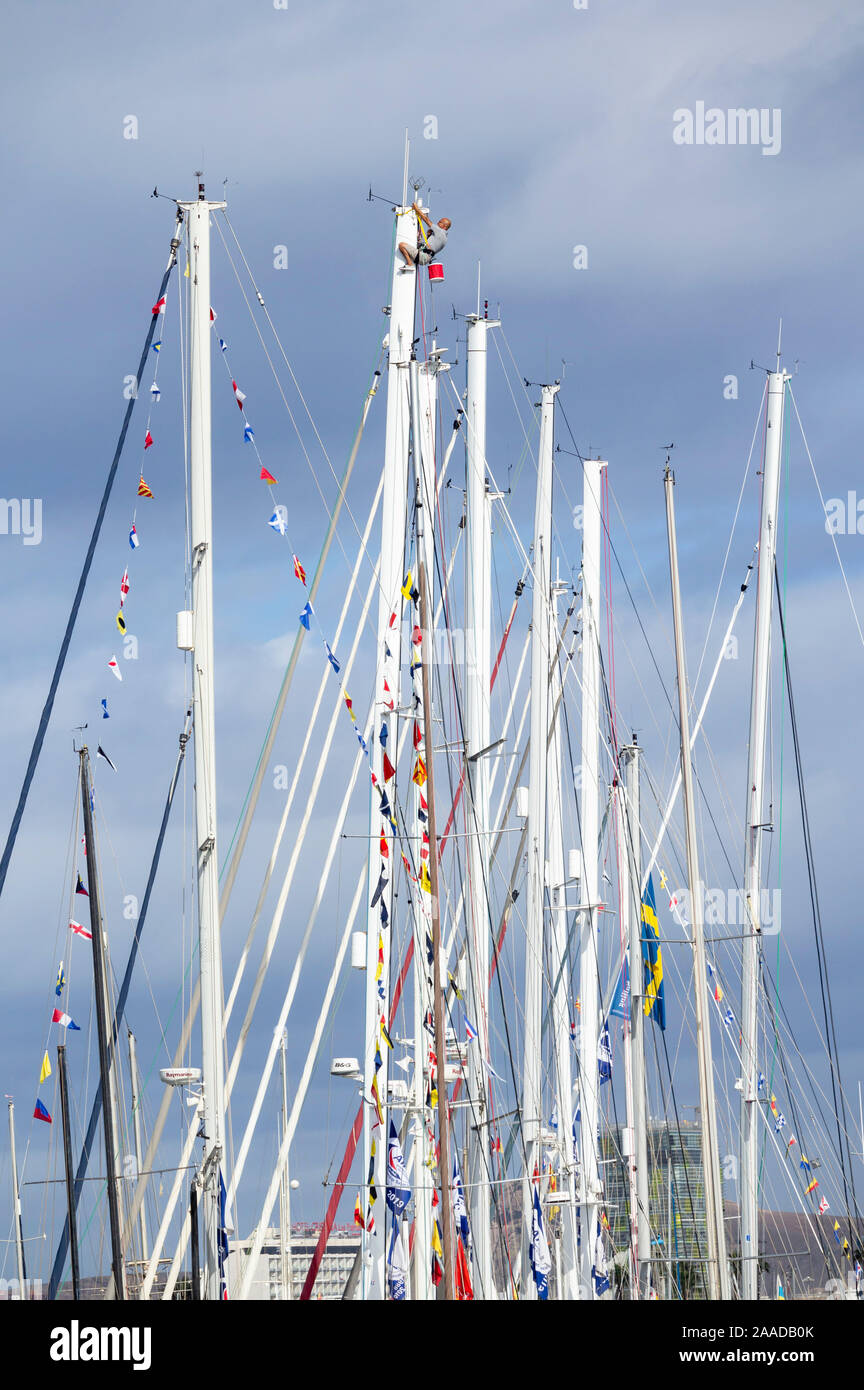 Las Palmas de Gran Canaria, Isole Canarie, Spagna. 21 Novembre, 2019. Un marinaio pende da un montante come equipaggi preparare i loro yacht per la più grande del mondo di transocean sailing event, l'arco transatlantica, che inizia domenica 24 novembre. La gara/rally inizia a Las Palmas e finiture in Rodney Bay su Santa Lucia nei Caraibi. Equipaggi provenienti da più di 40 paesi, compresi molti dalla Gran Bretagna, sarà a bordo di circa 300 yachts rendendo la traversata. Credito: Alan Dawson /Alamy Live News Foto Stock