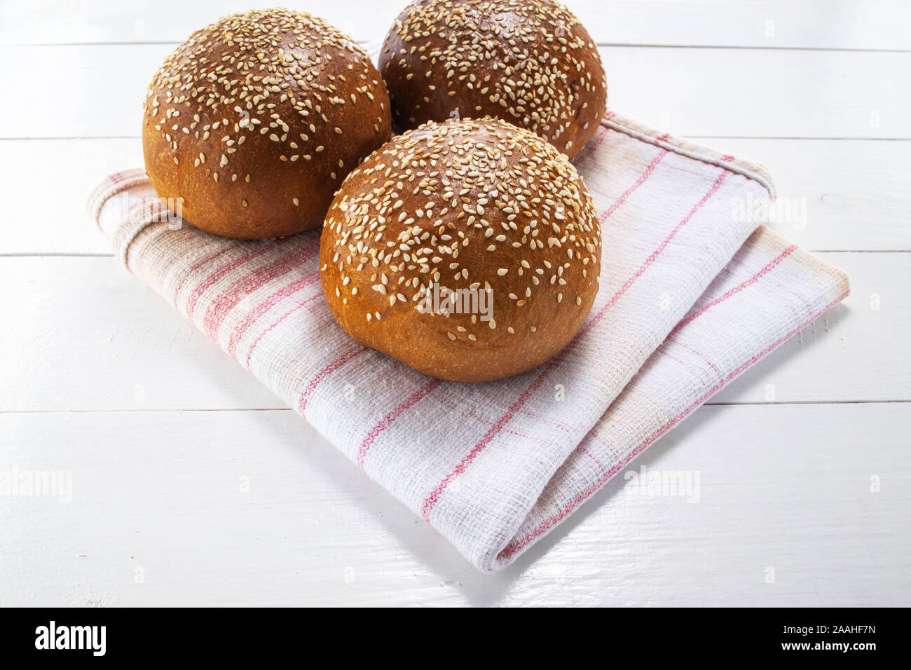 In casa del pane di pasta acida, round panini su vintage asciugatutto e sfondo di legno Foto Stock