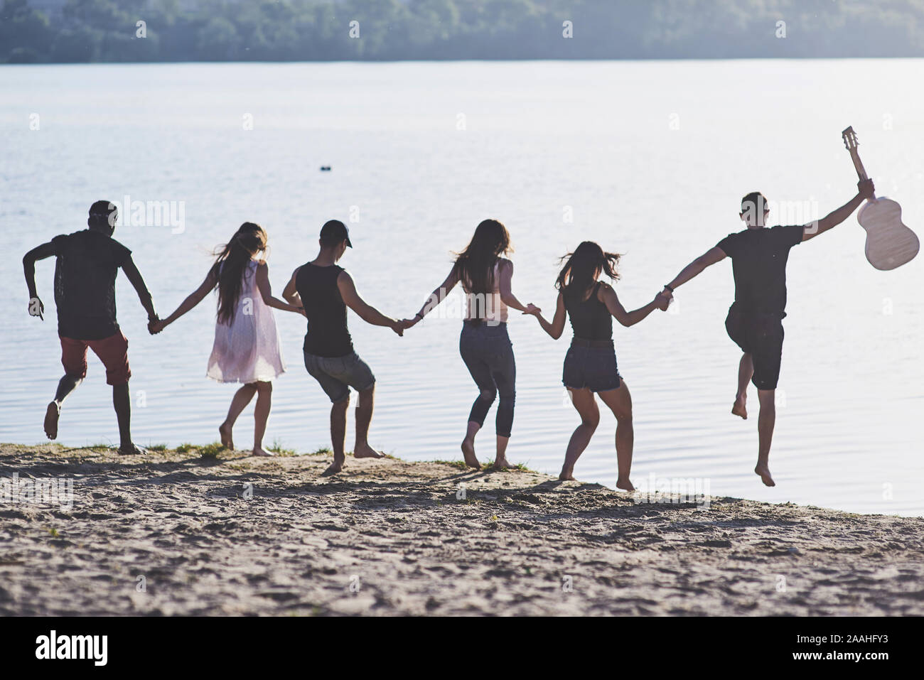 Happy amici divertirsi sulla spiaggia - Giovani giocando in aria aperta acqua su vacanze estive Foto Stock