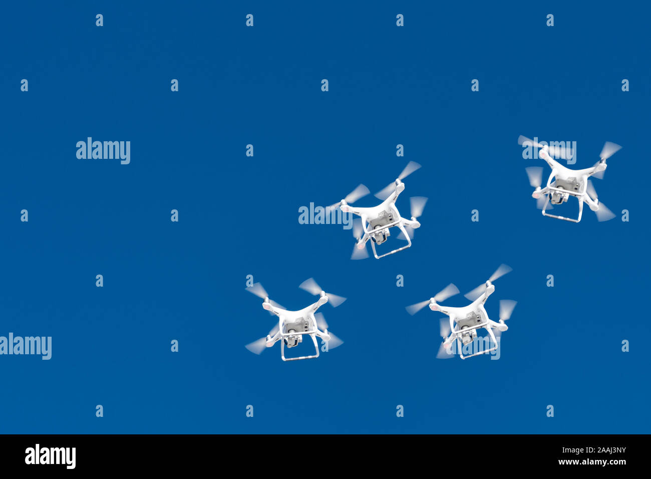 Decine di fuchi sciame nel cielo blu. Quadcopters fuchi con fotocamera digitale in aria sulla città. La nuova tecnologia in aero di ripresa fotografica e Foto Stock