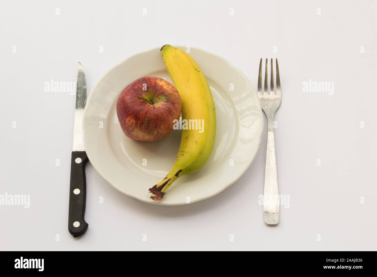 Banana e mela pasto, diete povere concept Foto Stock