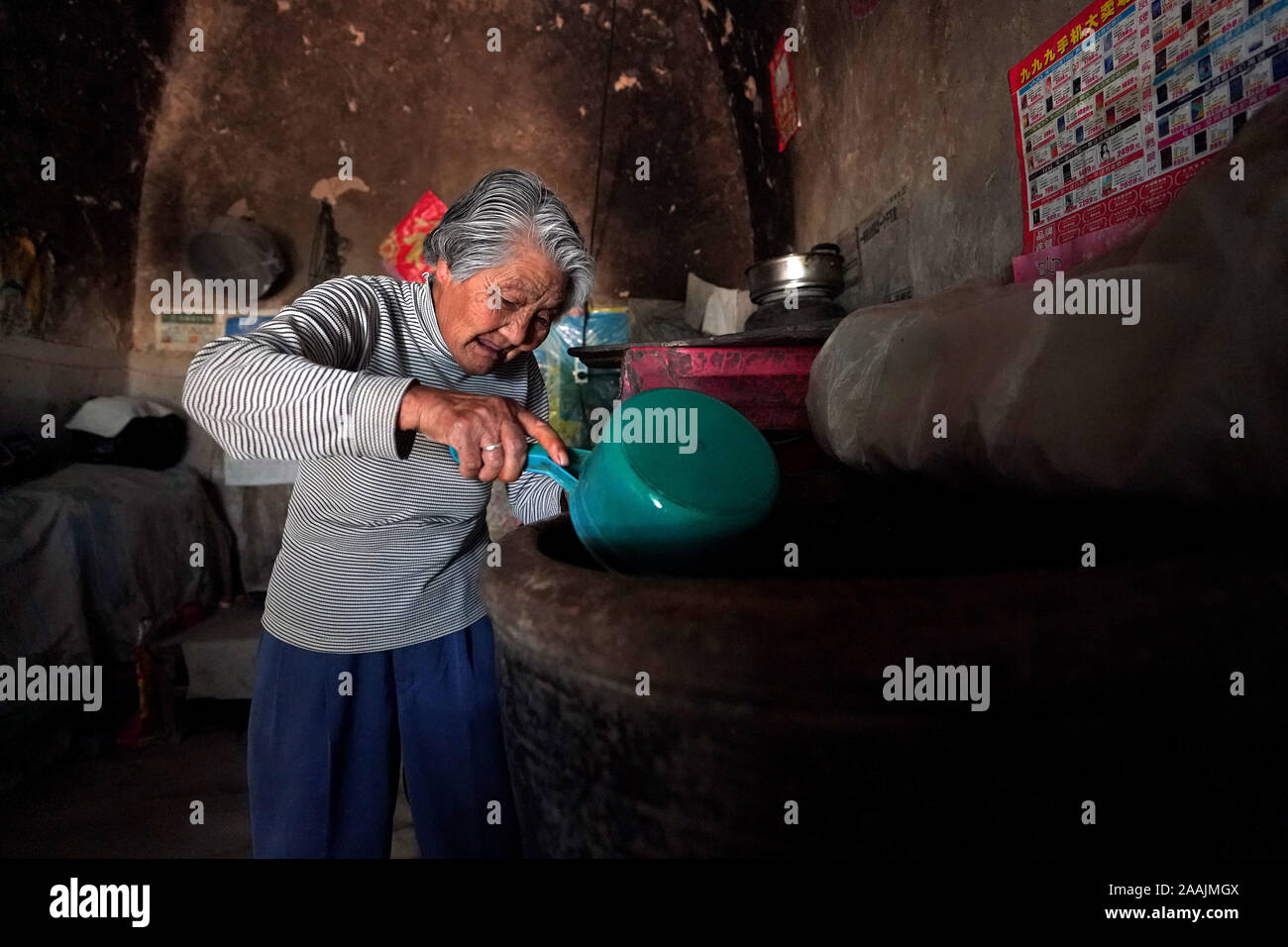 (191122) -- YICHENG COUNTY, nov. 22, 2019 (Xinhua) -- un abitante di un villaggio controlla il suo stock di acqua a casa nel villaggio di Nanling della contea di Yicheng, nel nord della Cina di nella provincia di Shanxi, 3 luglio 2019. Come l'interruttore è stato tirato, l'acqua forma di schizzo da 403 metri giù sotto. Villaggio Nanling molto prima di acque profonde è andato bene in servizio su un inizio inverno mattina. In passato il borgo, diffusione attraverso gli anfratti delle montagne Zhongtiao nel nord della Cina era basata esclusivamente sul fango box per conservare la sua preziosa acqua potabile per secoli. Ossessionato dalla paura della siccità, generazioni aveva sognato di accesso diretto Foto Stock