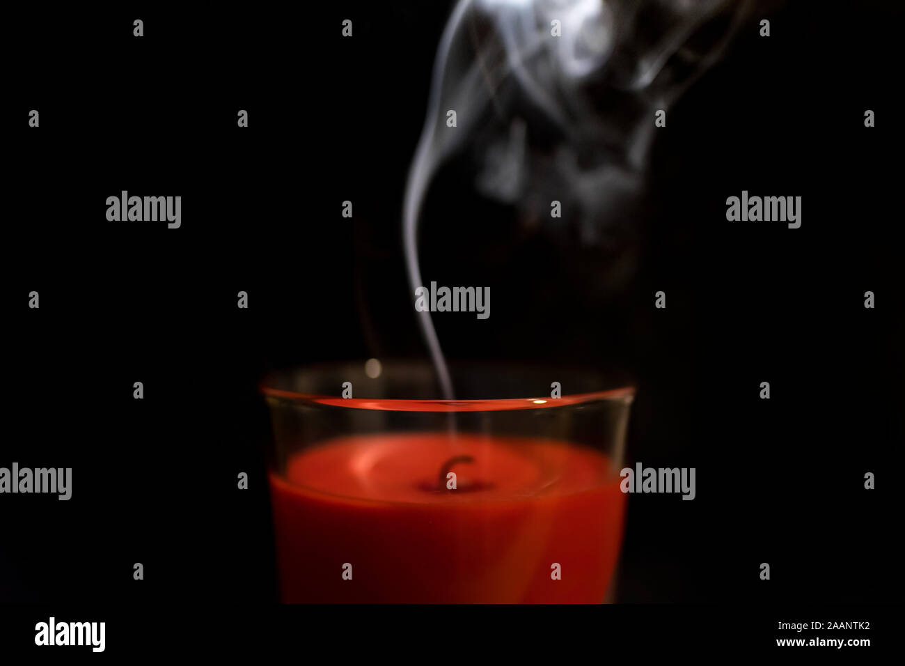 Soffiato fuori candela rossa su sfondo nero Foto Stock