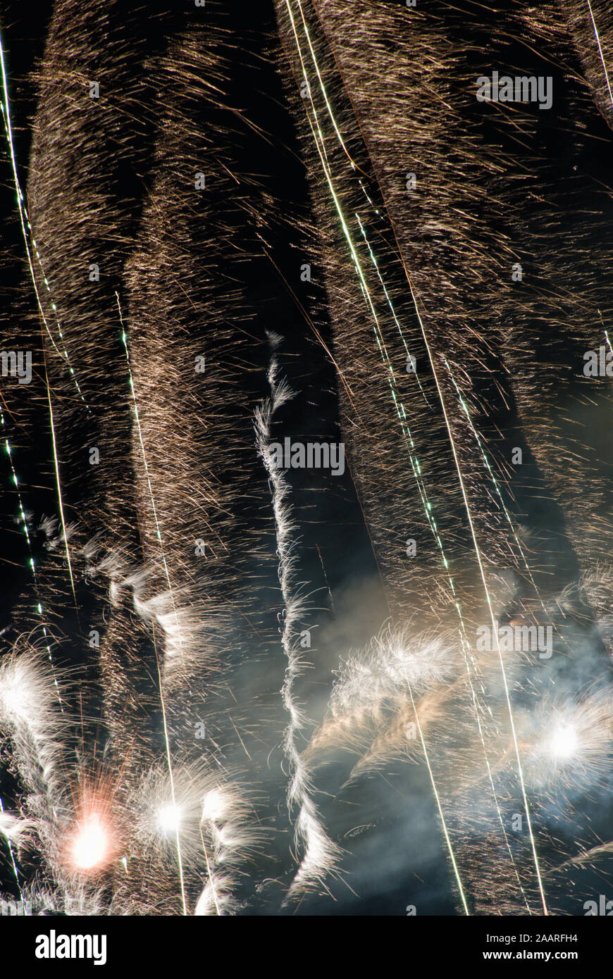 Un luminoso e colorato di fuochi d'artificio di fumo e di luce e di colore e movimento durante una vacanza celebrazione come essa illumina il cielo di notte. Foto Stock