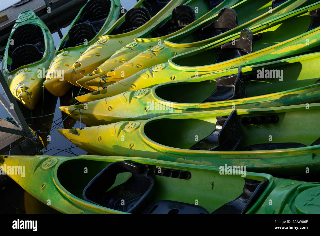 Il lago di kayak attraccata ad un molo nel cerchio astratto, verniciato di verde e giallo Foto Stock