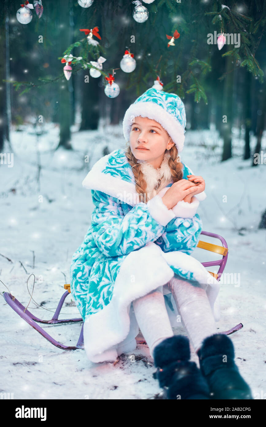 Nuovo anno. bambina slittino nei boschi per natale Foto Stock