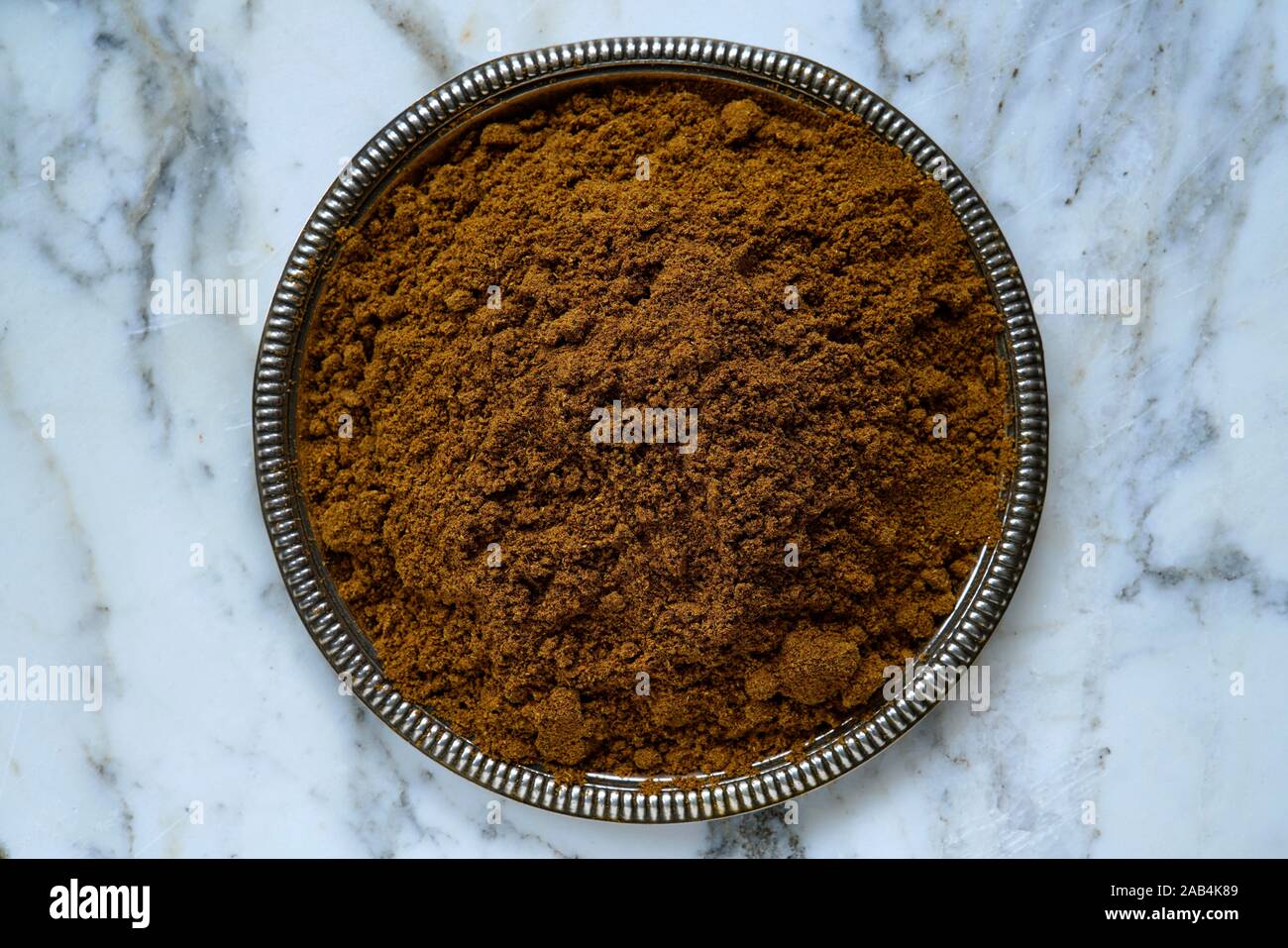 Masala miscela di spezie in polvere in una ciotola, India Foto Stock