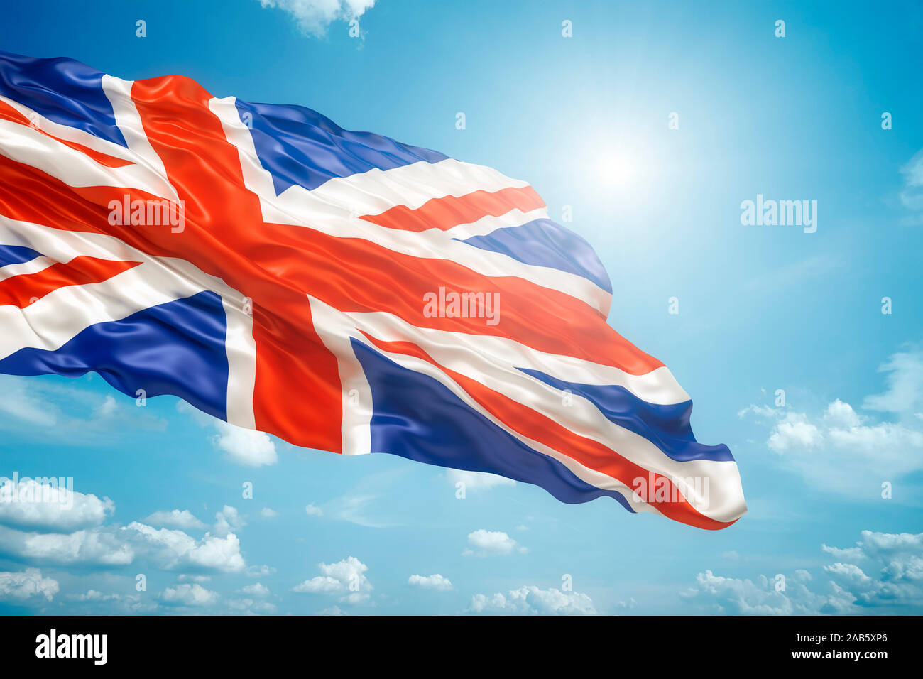 Die wehende Unione bandiera vor einem strahlend blauen Himmel Foto Stock
