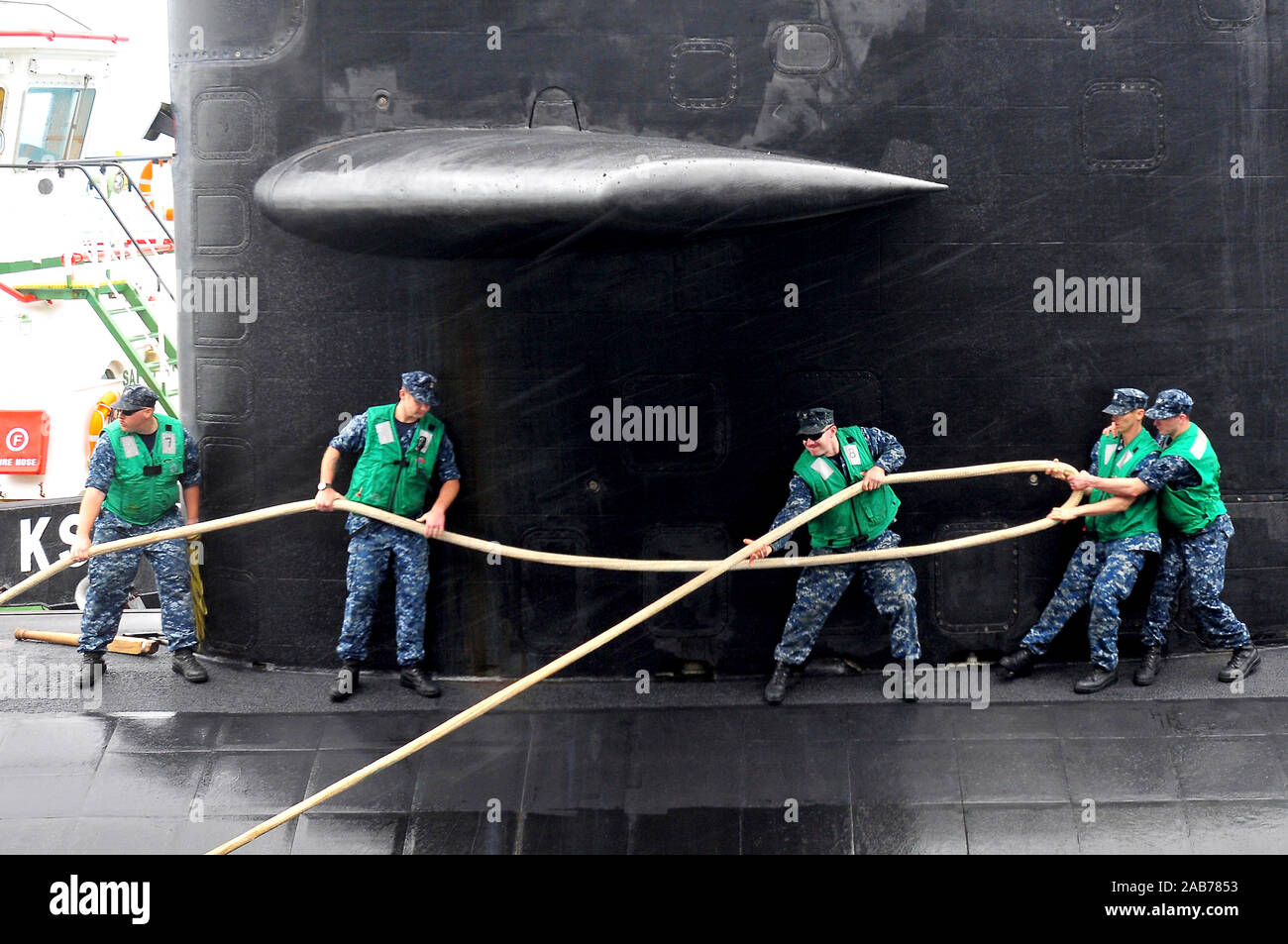 (Sett. 8, 2011) marinai fissano il Los Angeles-class attack submarine USS Dallas (SSN 700) in Diego Garcia. Foto Stock