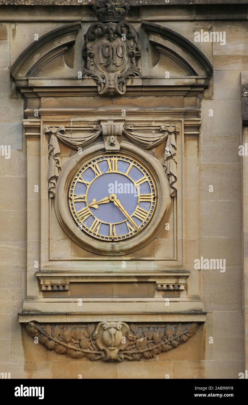 Orologio sulla parete sopra l'ingresso alla cappella e sala nel quad di fronte al St John's College Oxford fatto di arenaria tipica dalla zona Foto Stock