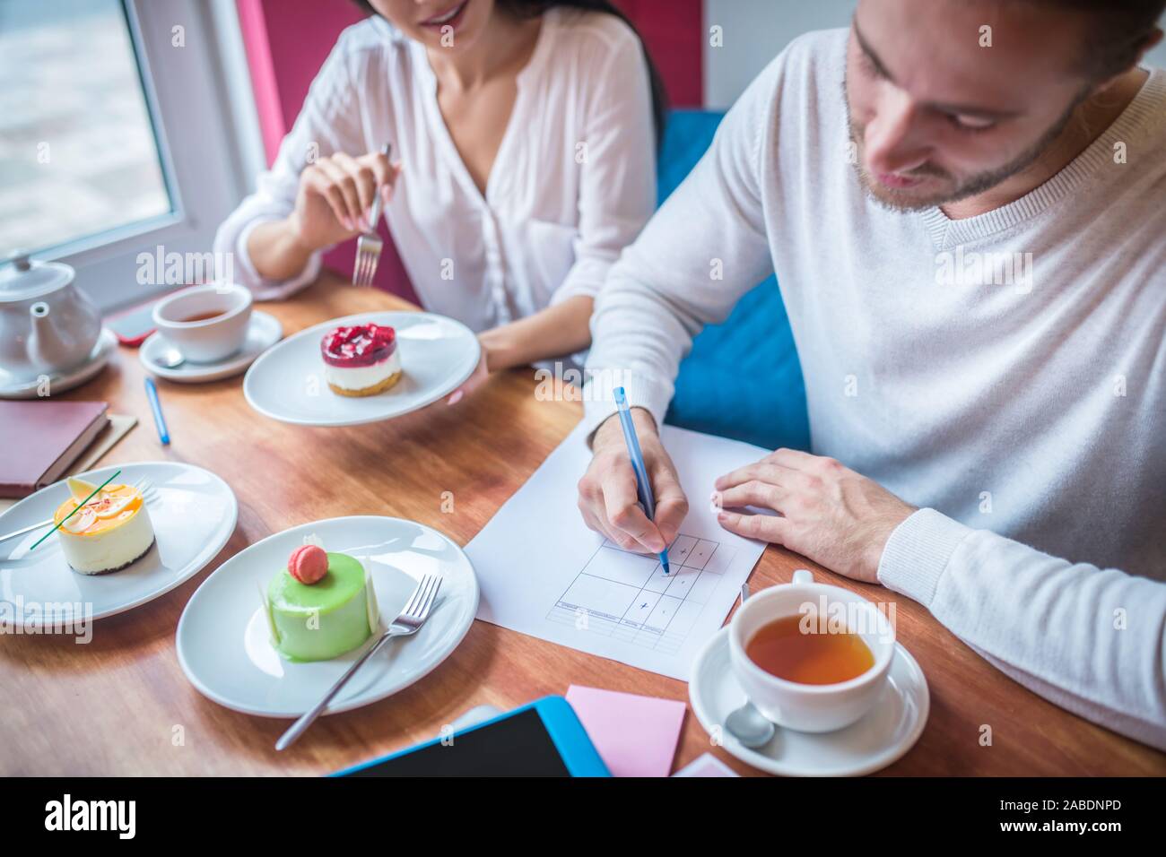 Imprenditore rendendo note durante la revisione di dolci per i loro menu Foto Stock