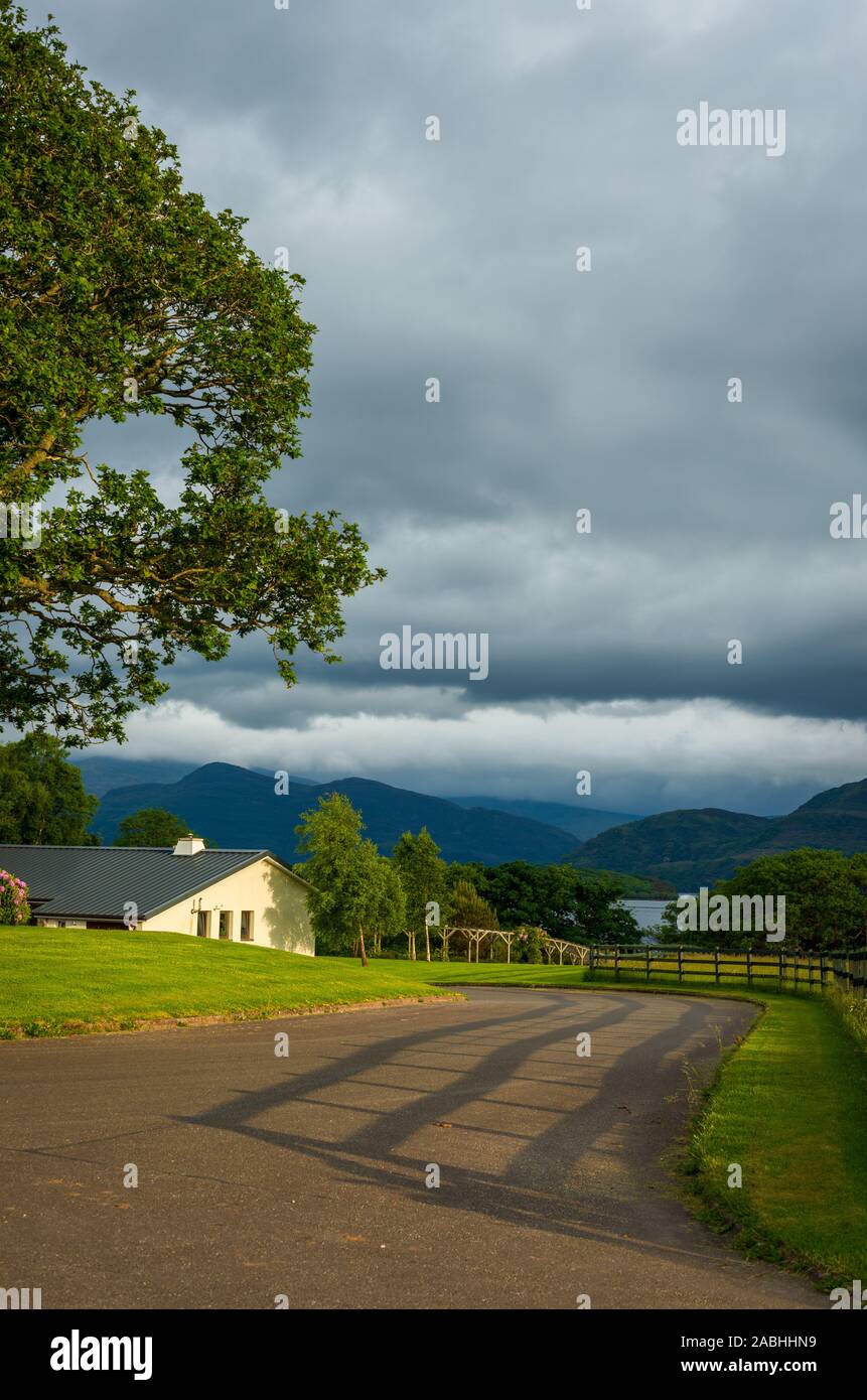 Idilliaco paesaggio rurale con cottage e vialetto ai laghi di Killarney, Killarney, County Kerry, Irlanda Foto Stock