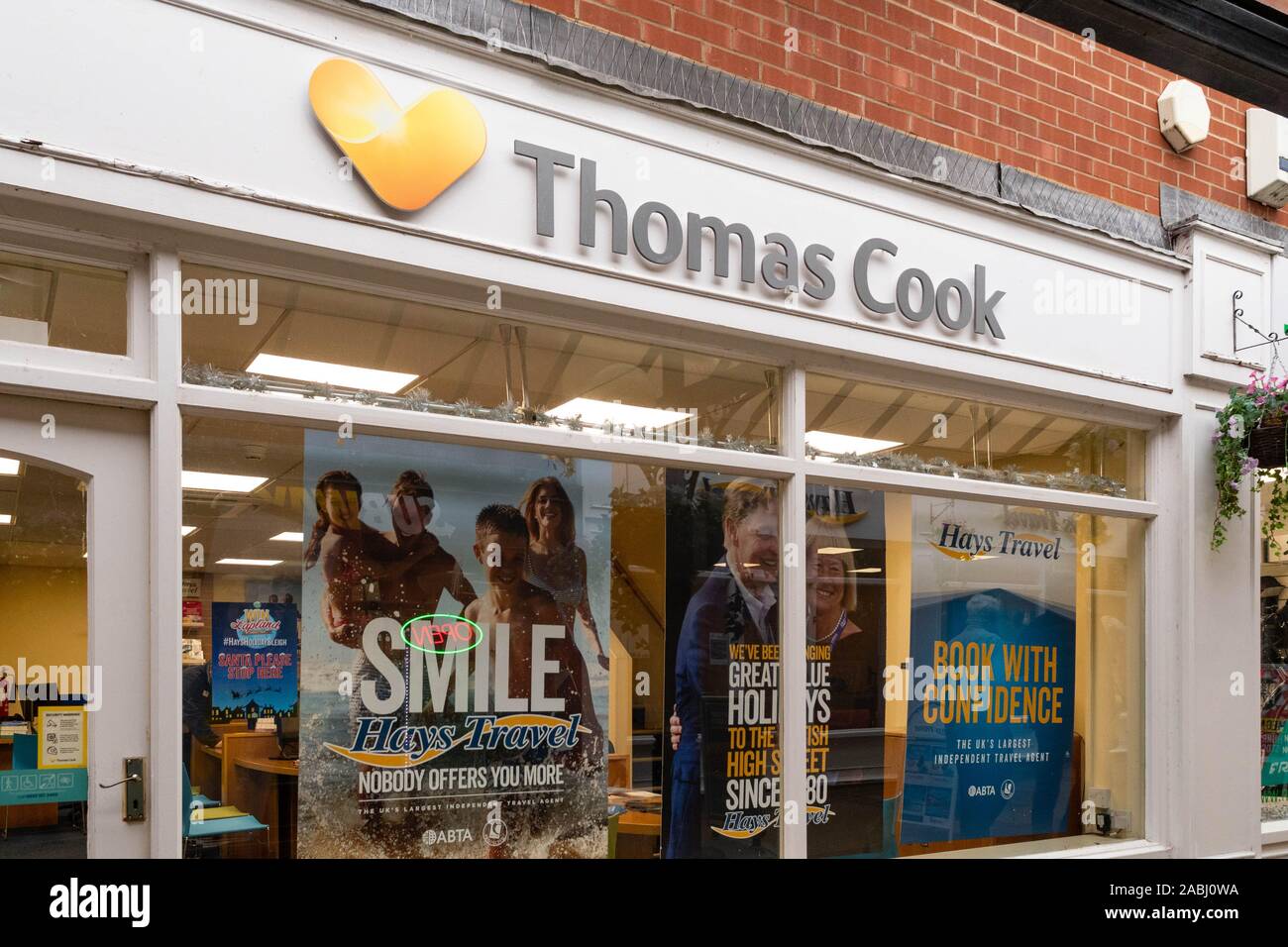Ex Thomas Cook store ora negoziazione come Hays Travel con manifesti nella finestra prima di negozio di fronte alterazioni, mugnai a piedi, Fakenham, Norfolk, Inghilterra, Regno Unito Foto Stock
