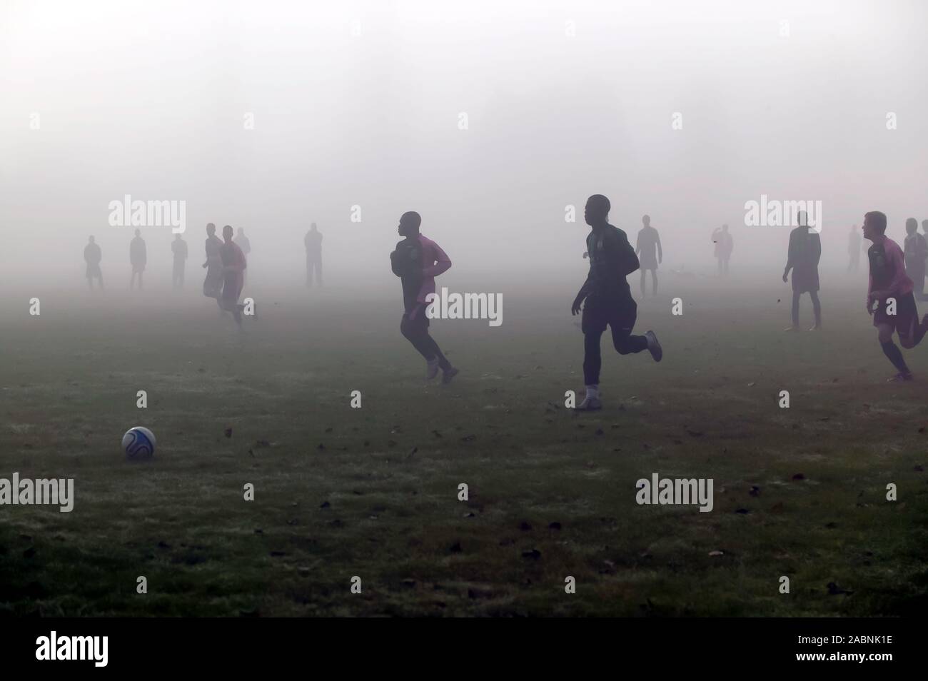 I calciatori giocare in condizioni di nebbia sulla Warren Avenue campi da gioco Foto Stock