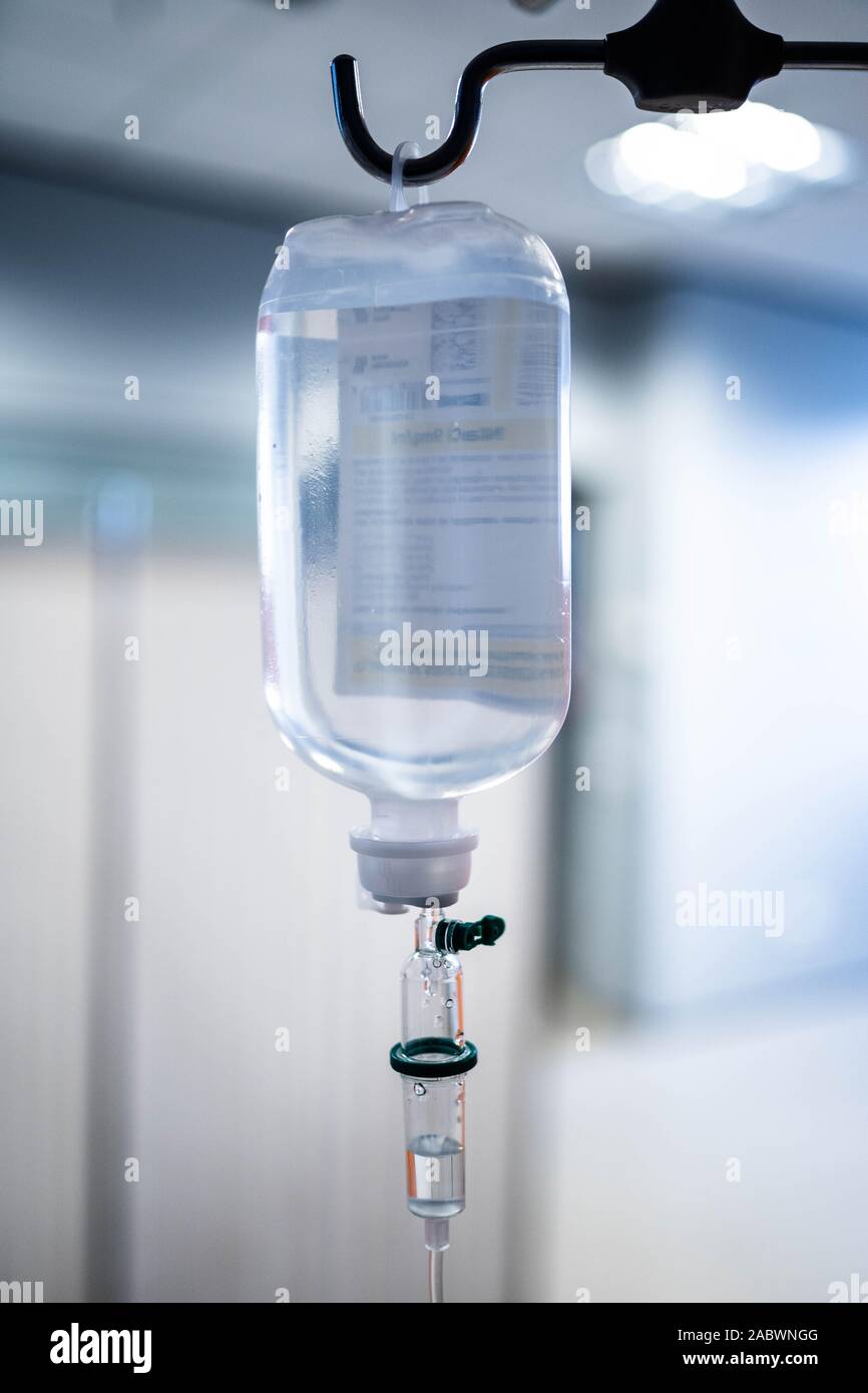 Soluzione salina flebo IV liquido per infusione in background dell'ospedale. Infusione endovenosa apparecchi per fleboclisi in ospedale Foto Stock