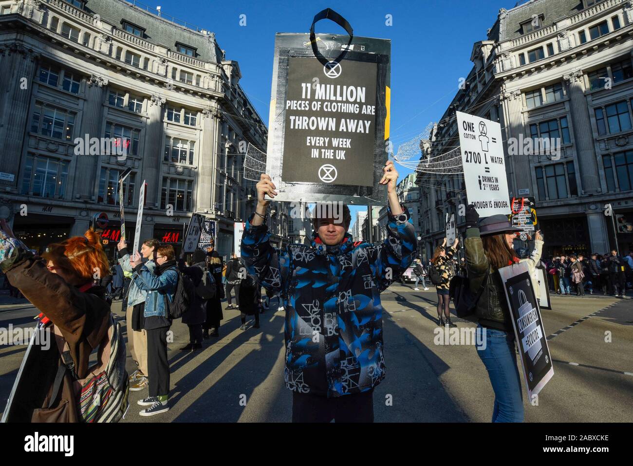 Londra, Regno Unito. Il 29 novembre 2019. Membri della ribellione di estinzione inscenare una protesta a Oxford Circus sul Venerdì nero. Gli attivisti protestano contro usa e getta di moda e di un eccessivo consumo dei consumatori il giorno quando i rivenditori stanno offrendo notevoli sconti sui loro prodotti. Credito: Stephen Chung / Alamy Live News Foto Stock