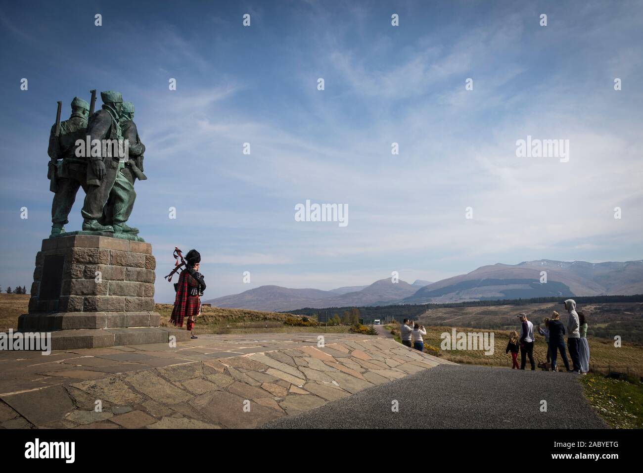 Un bagpiper svolge nella parte anteriore della seconda guerra mondiale Commando Memorial statua a Spean Bridge, commissionato nel 1949 dallo scultore Scott Sutherland. Foto Stock