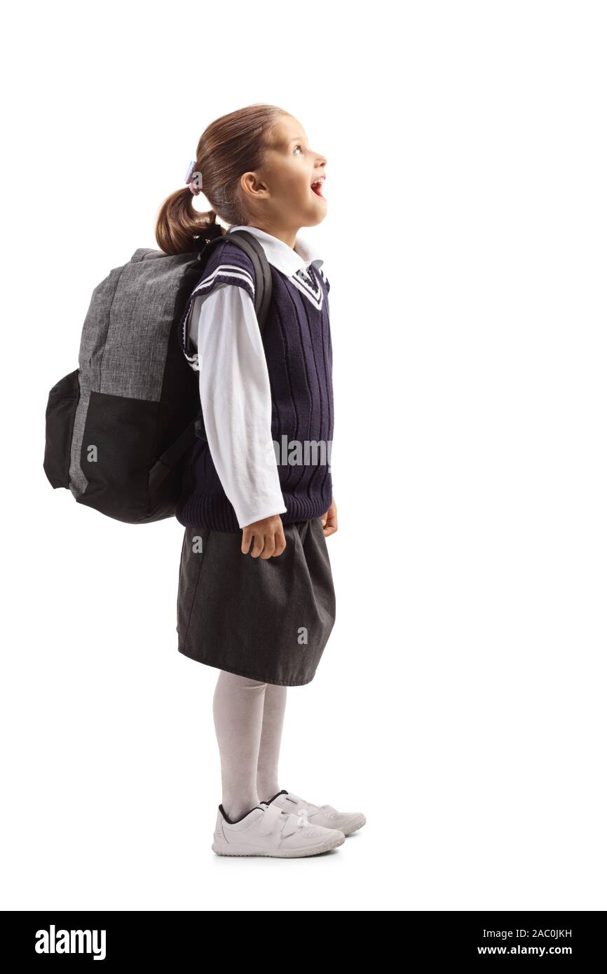 Happy Little Schoolgirl guardando in alto isolato su sfondo bianco Foto Stock
