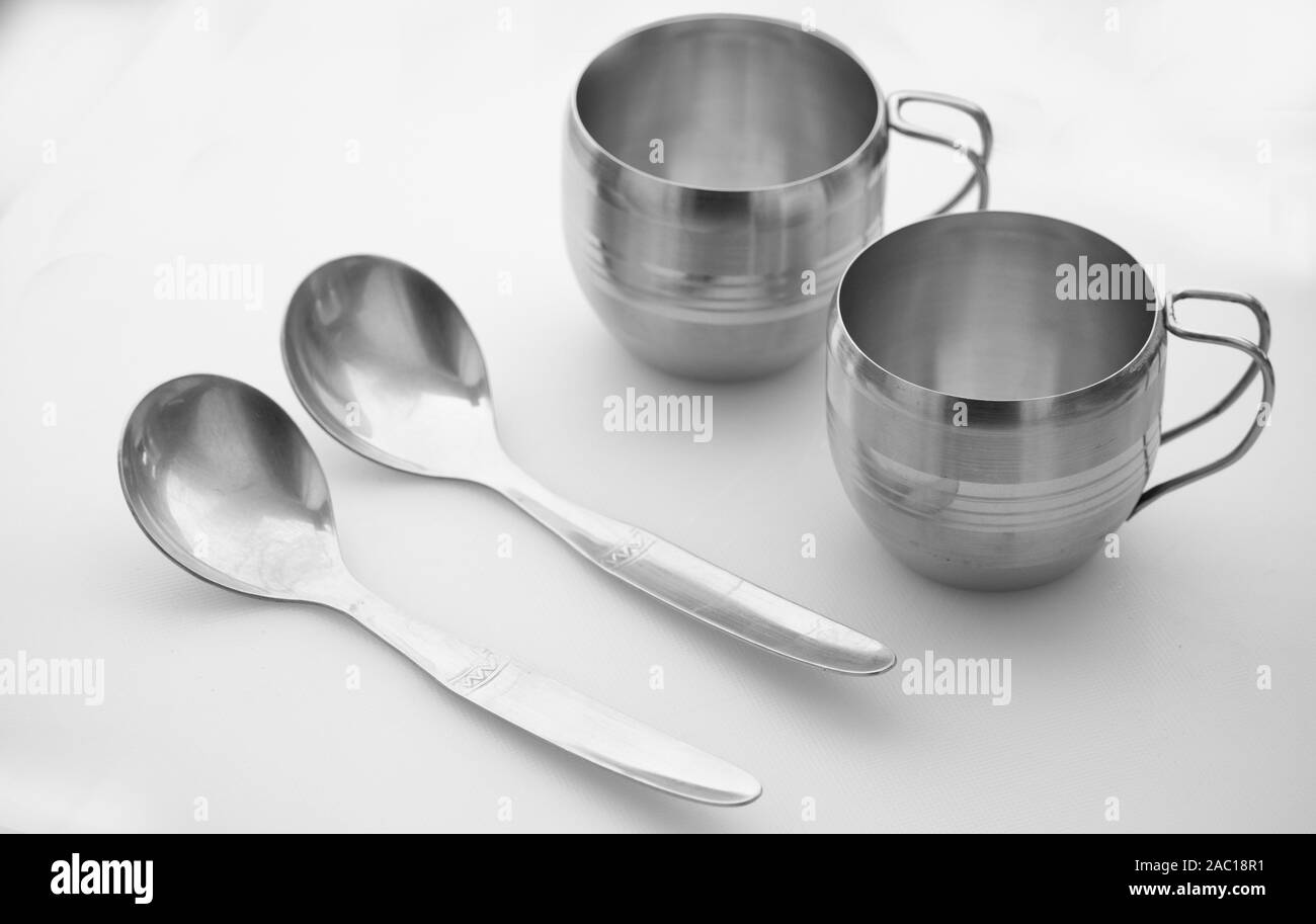 Boccale di metallo con cucchiaio di traino isolati su sfondo bianco Foto Stock