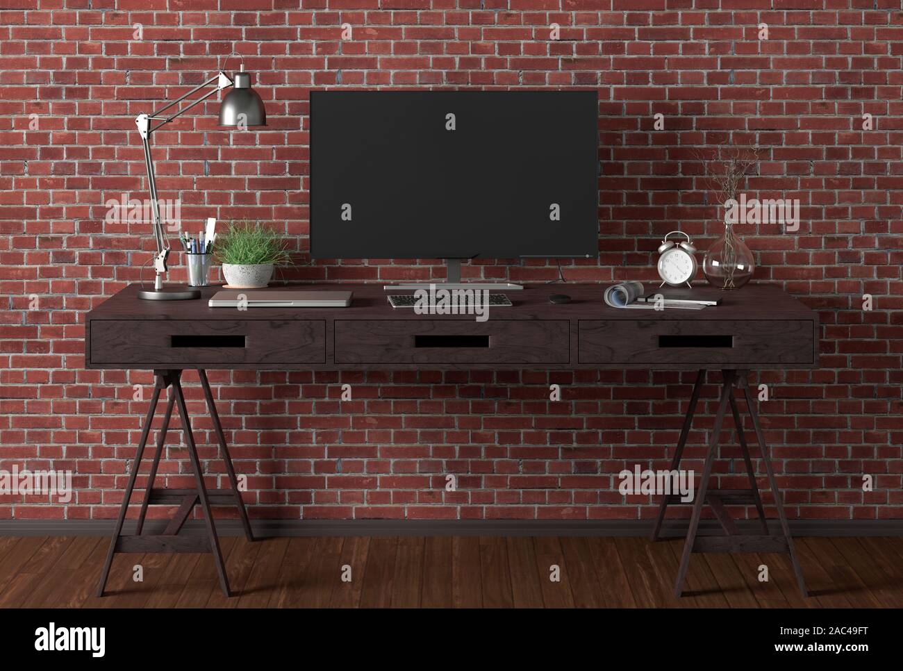 Scrivania con monitor per computer. Posto di lavoro nello studio con parete in mattoni rossi. Tracciato di ritaglio intorno alla visualizzazione Foto Stock