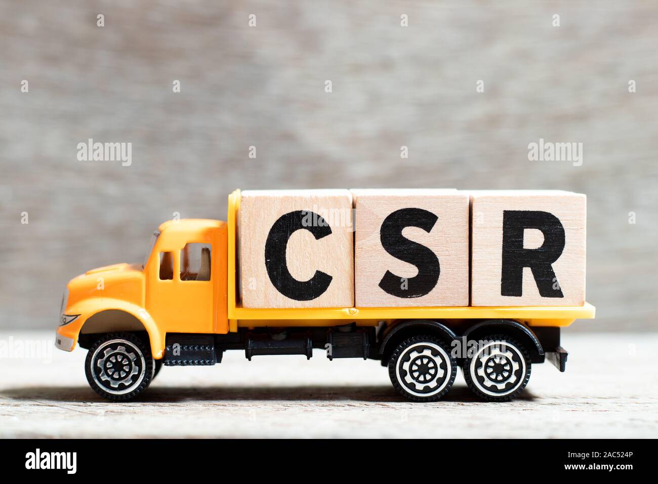 Carrello attesa blocco lettera nella parola CSR (abbreviazione di corporate social responsibility) su uno sfondo di legno Foto Stock