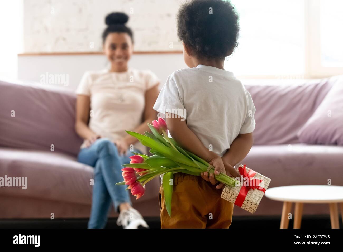 Little Boy biracial rendere sorpresa di compleanno per giovani mom Foto Stock