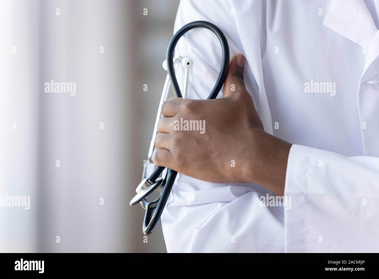Close up americano africano giovani medici di sesso maschile mani, tenendo phonendoscope. Foto Stock