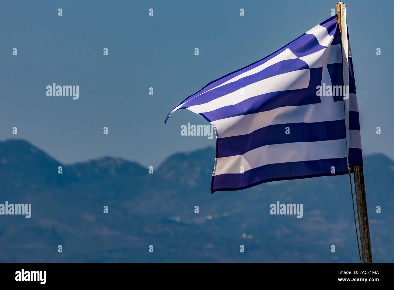 Nazionale Greco di bandiera sventola sul cielo blu sullo sfondo. Repubblica Ellenica, GR Foto Stock