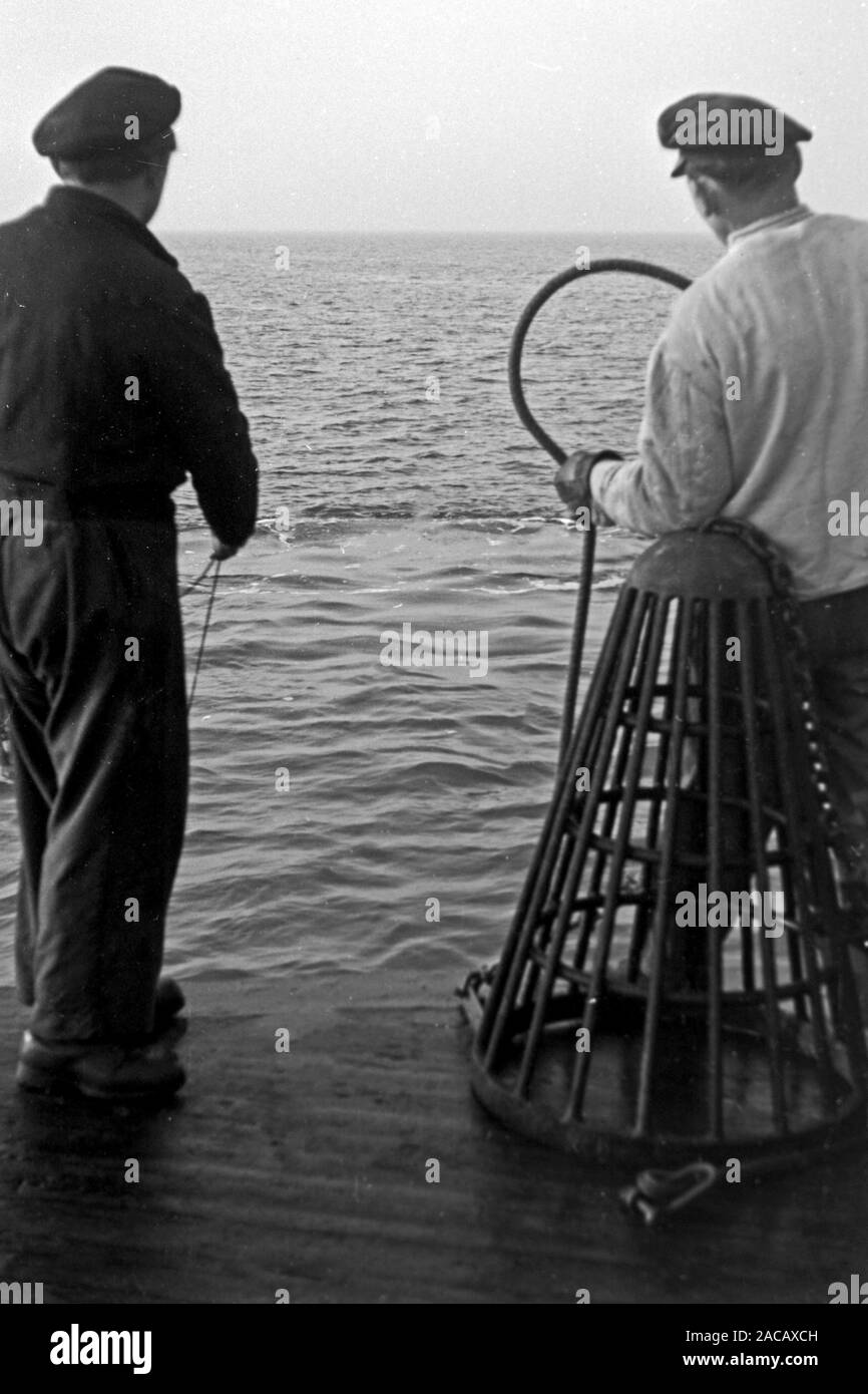 Schiffsarbeiter setzen Bojen, Emden, Niedersachsen, Deutschland, 1950. Nave i lavoratori messi boe, Emden, Bassa Sassonia, Germania, 1950. Foto Stock