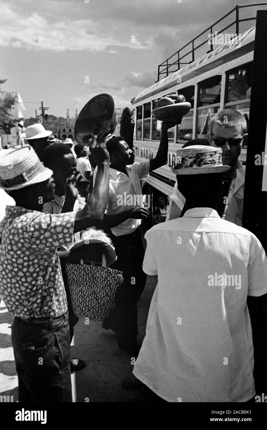 Fliegende Händler bieten ihre Waren durchreisenden Bus-Fahrgästen un, 1967. Gli operatori mobili che offrono la loro merce per i passeggeri di un autobus in transito, 1967. Foto Stock