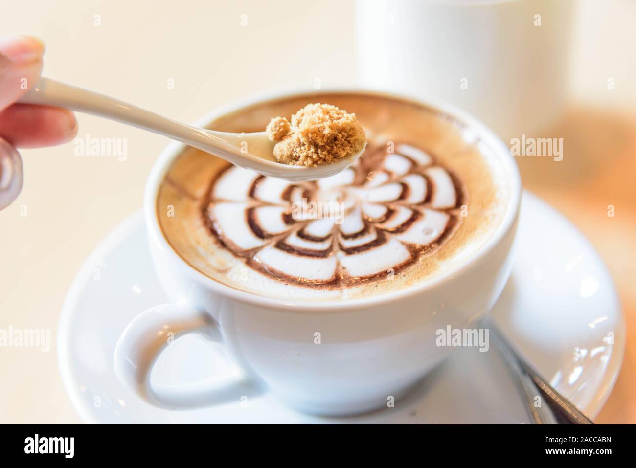 Aggiungere lo zucchero di caffè caldo Foto Stock