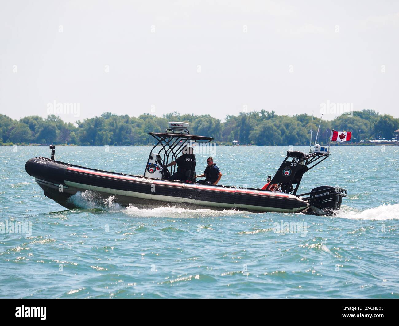 Gli ufficiali della polizia di Toronto si siedono su un motoscafo che corre sull'acqua. Foto Stock