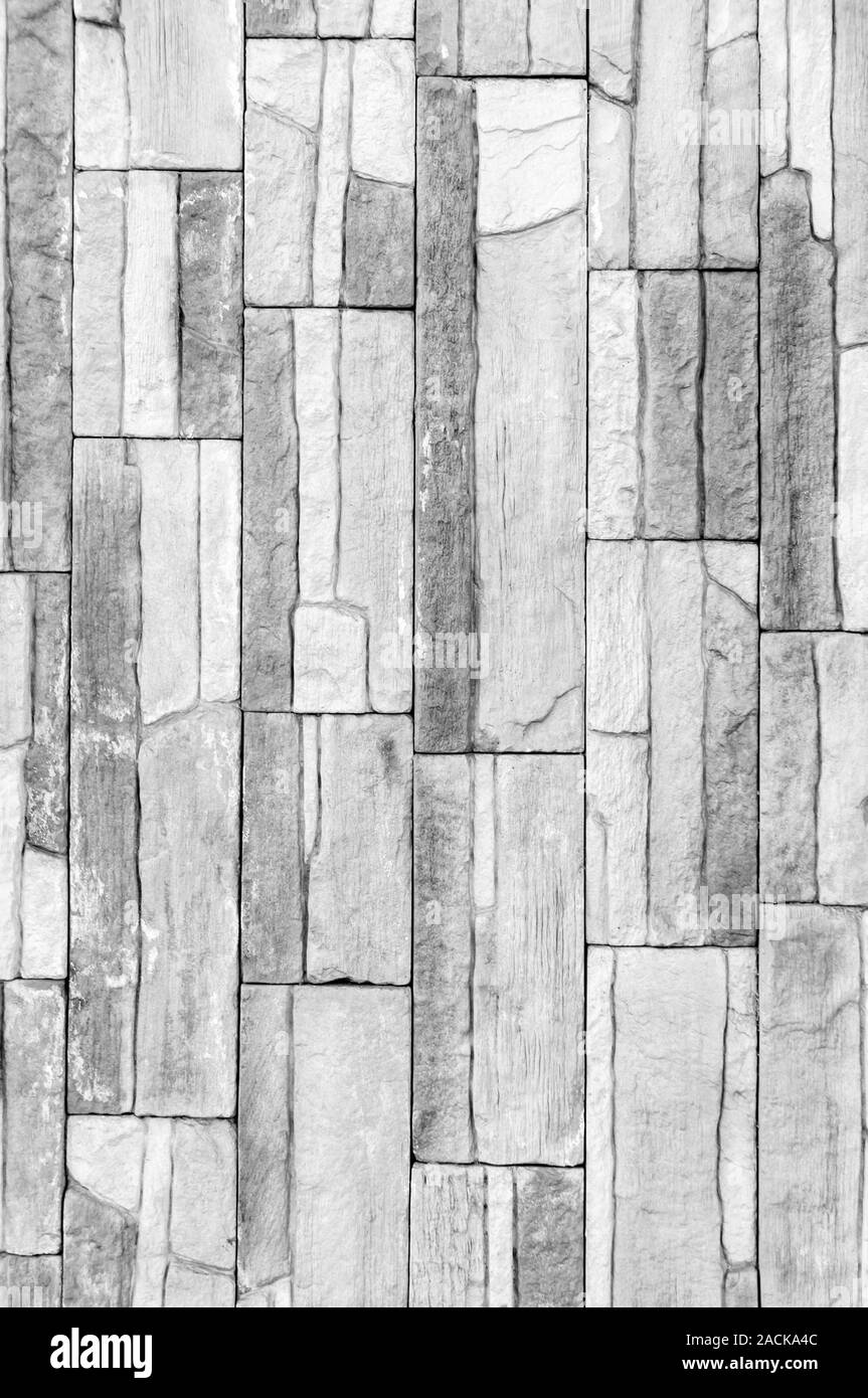 Tile parete in pietra texture pattern. Per lo sfondo o il pavimento. Frammento di una parete da una pietra scheggiata. Foto Stock