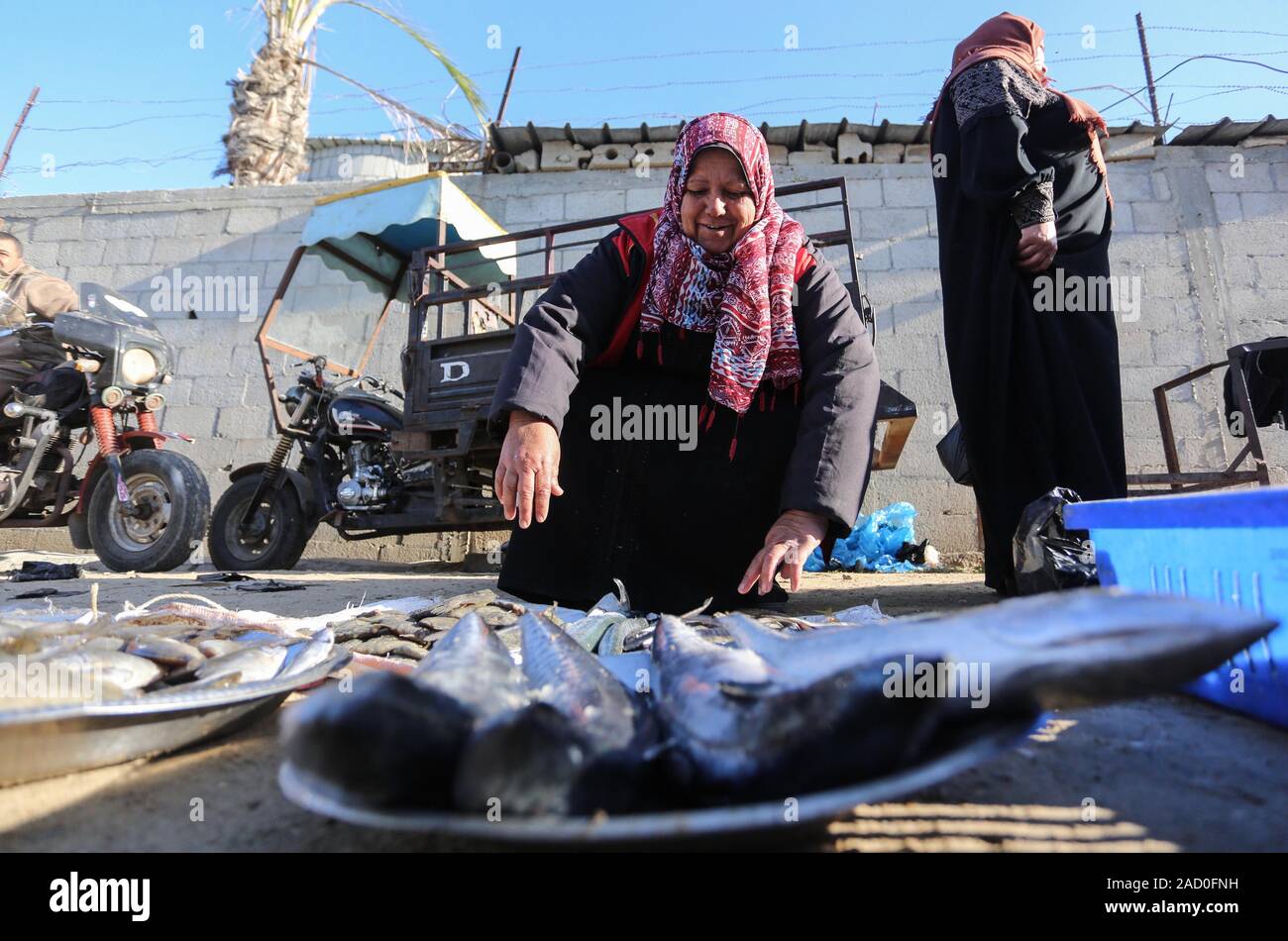 Deir Al Balah, Striscia di Gaza, Territori palestinesi. 3 dicembre, 2019. Fisherwoman palestinese Um Jimal al-Akra, la vendita del pesce in un mercato di Gaza City, sul dicembre 03, 2019. Dopo che lei ritorna a Gaza City con pesce, Um Jimal compete con altri operatori di mercato del pesce a Deir Al Balah distretto, dove la più importante fonte di vita è la pesca industria: Credito Ashraf Amra/immagini APA/ZUMA filo/Alamy Live News Foto Stock