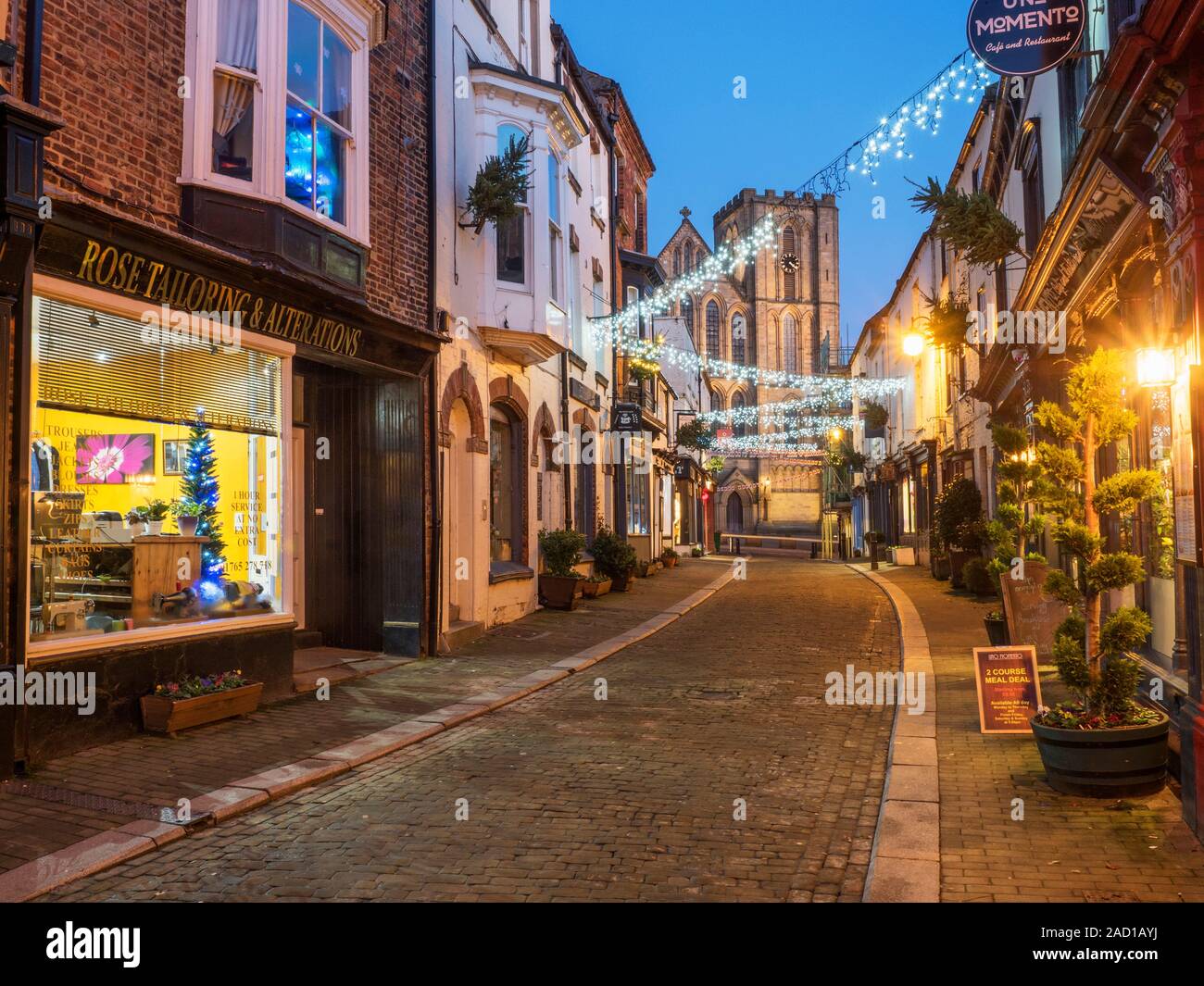 Le luci di Natale lungo Kirkgate e cattedrale di Ripon al crepuscolo Ripon North Yorkshire, Inghilterra Foto Stock