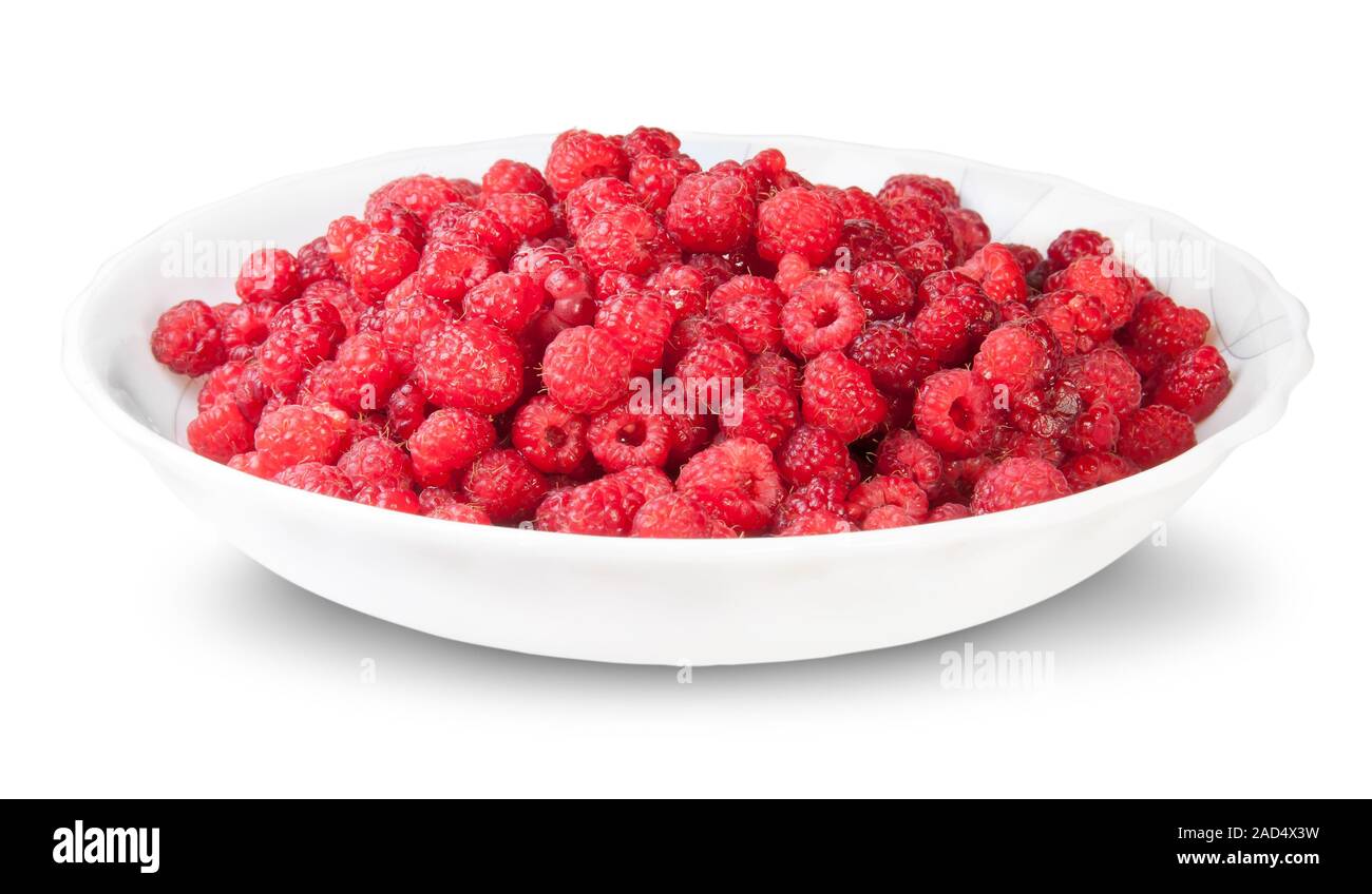 Pila di lamponi freschi su una piastra bianca Foto Stock
