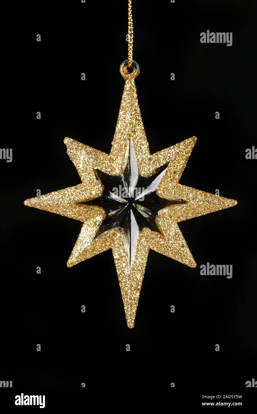 Oro glitter stella di Natale isolata contro il nero Foto Stock