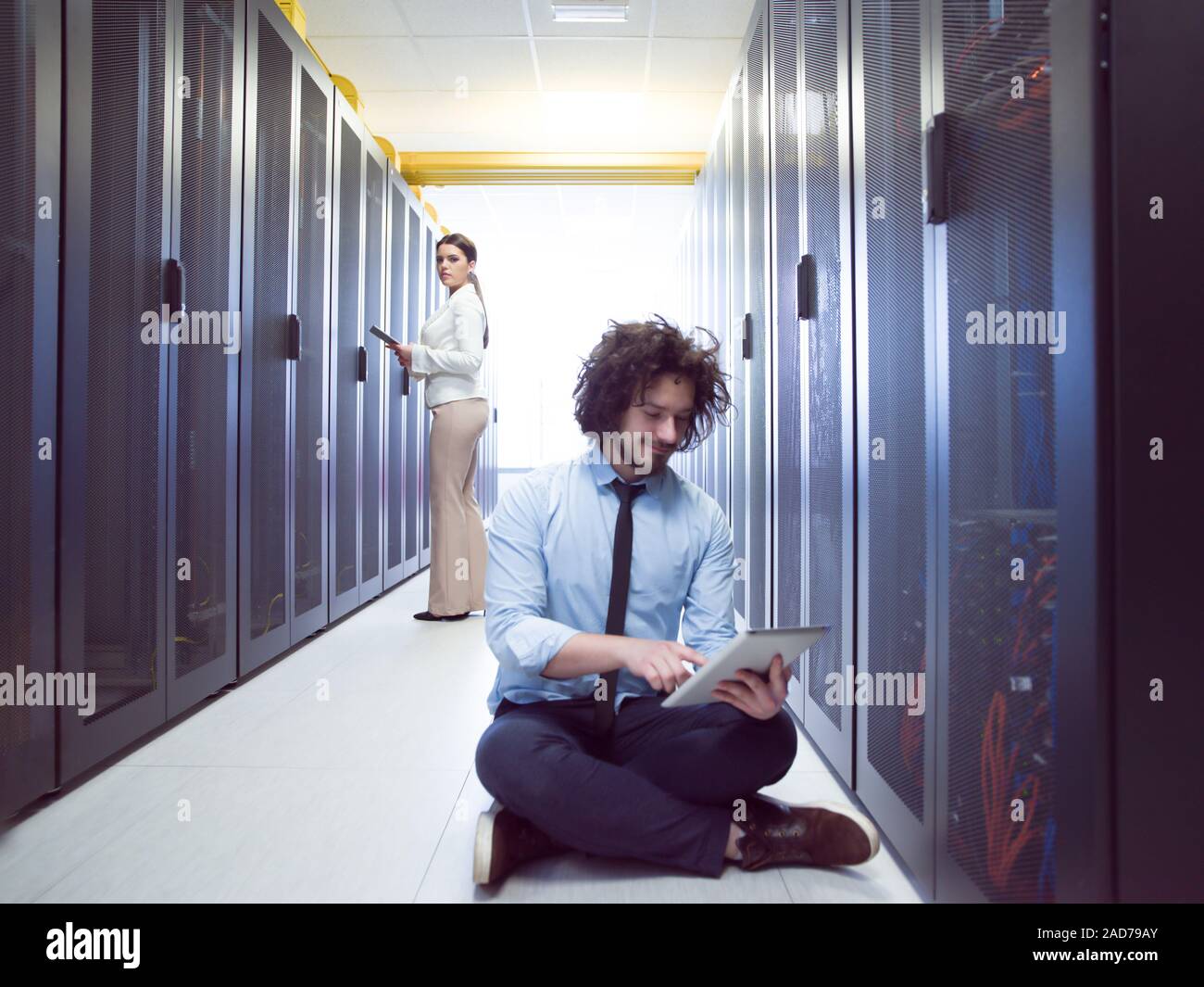 Giovani tecnici che lavorano insieme su server Foto Stock