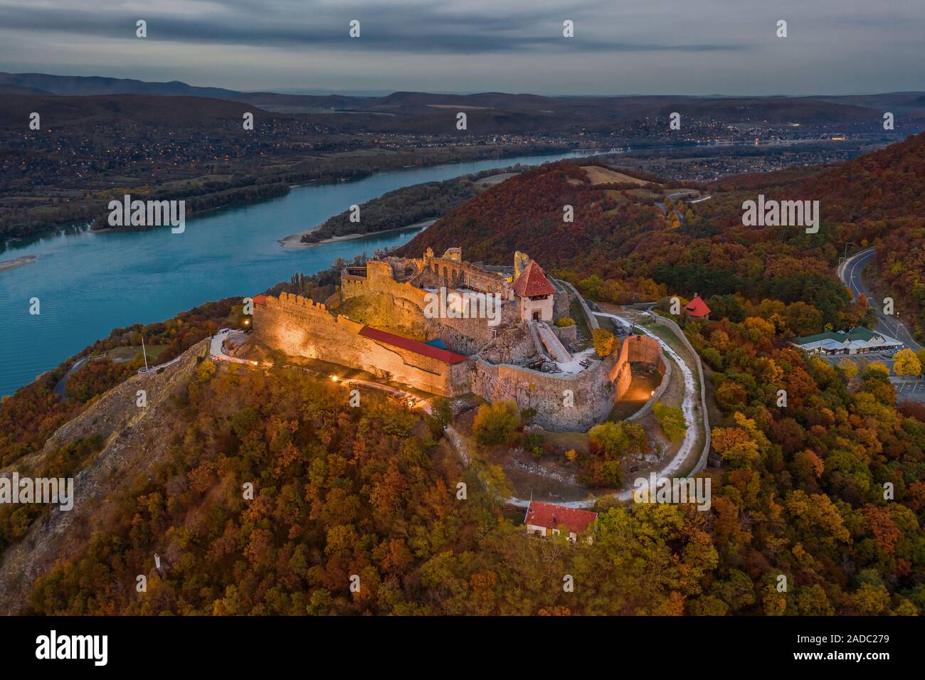 Visegrad, Ungheria - Aerial drone vista sul bellissimo castello di elevata di Visegrad con fogliame di autunno e gli alberi. Dunakanyar a sfondo Foto Stock