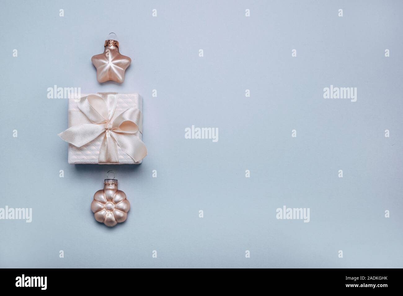 Piccola confezione regalo con decorazioni di Natale sfondo azzurro. Lay piatto Foto Stock