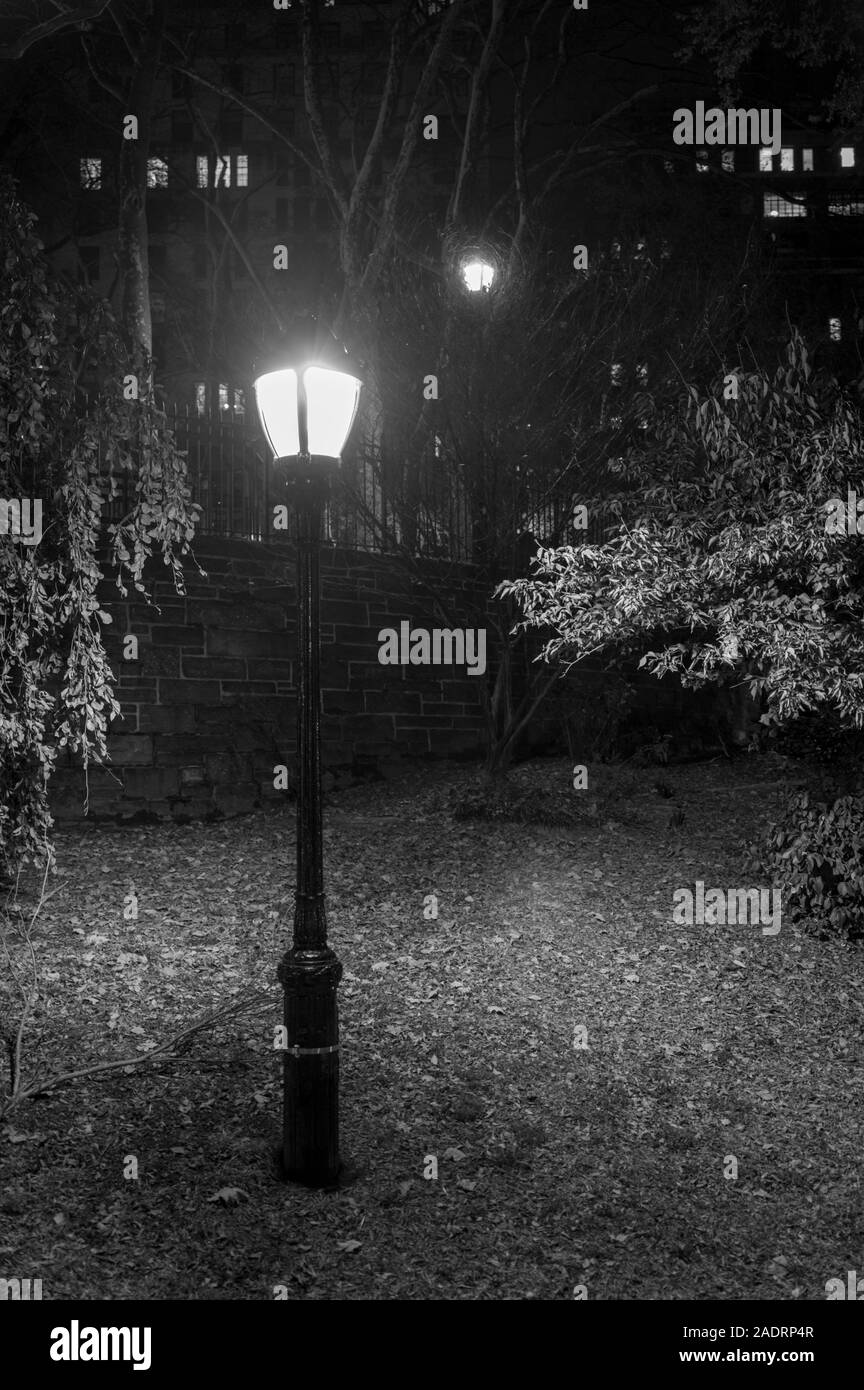 Vecchia strada lampada in un parco pubblico di notte, nell'Upper East Side di Manhattan, New York City, in bianco e nero Foto Stock