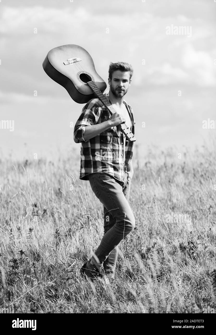 Un musicista in cerca di ispirazione. Wanderlust concetto. Ispirando la natura. Ragazzo con la chitarra a contemplare la natura. In cerca di muse. Uniti con la natura. La vacanza estiva. Trasognata wanderer. Atmosfera pacifica. Foto Stock